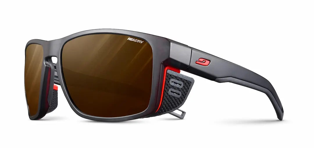 Julbo Shield M Sunglasses - Black Translucent - Neon Orange frame REACTIV light changing - Polarized lenses